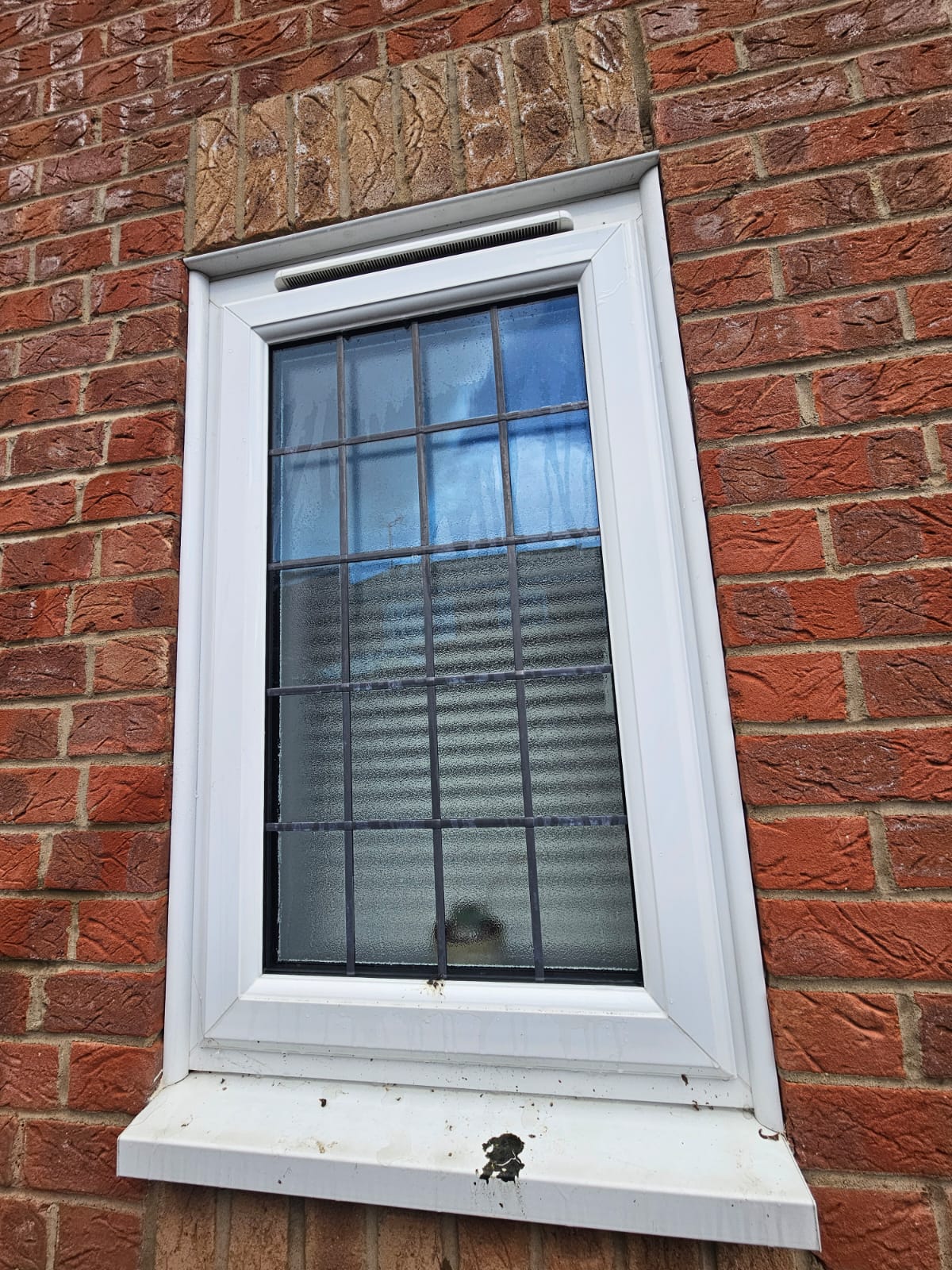 Before window cleaning showing dirt and marks on the sill and glass